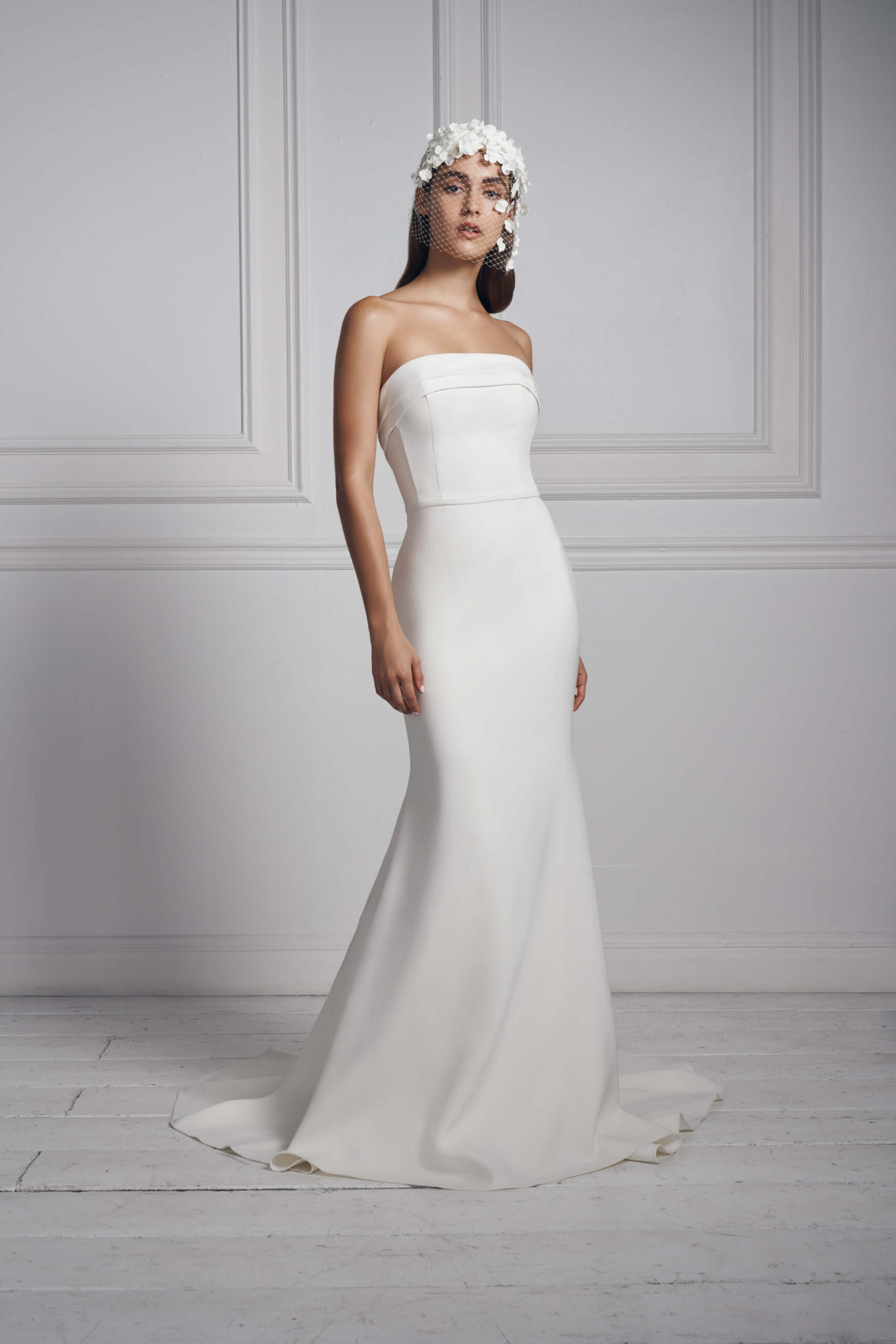 Anne Barge's columnar strapless bridal gown comes with arched pleated cuffs