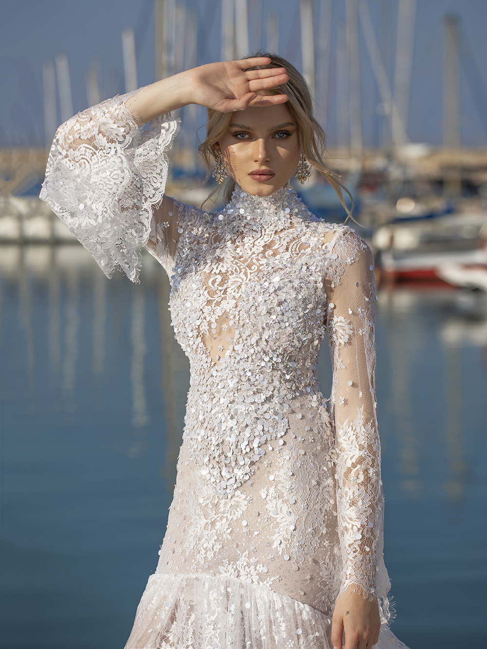 From The Love Story Collection. High neckline and signature long sleeves with a lace flare. Helena hugs the body and opens into an exceptional train.