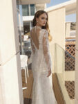 utilizing a unique display of laces, calypso is a nontraditional approach to a romantic bridal gown. Lace adorns the plunging neckline to create a decorative illusion that parallels the detailing in the flare sleeves. As the sheath gown opens into a lace skirt, Calypso creates a brilliant touch of glowing details. From the back, an open-v back parallels to an open v-neckline for design cohesiveness. Shop Lian Rokman's Designs