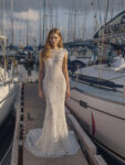 A play on both conservative and sheer detailing, Freya is a cap sleeve high neckline front with a deep keyhole back lined with 3d flowers and petals. From the hips, Freya opens conservatively into a sheath skirt with an exceptional train. Celebrate your special day with the breadth and depth of the Freya gown.