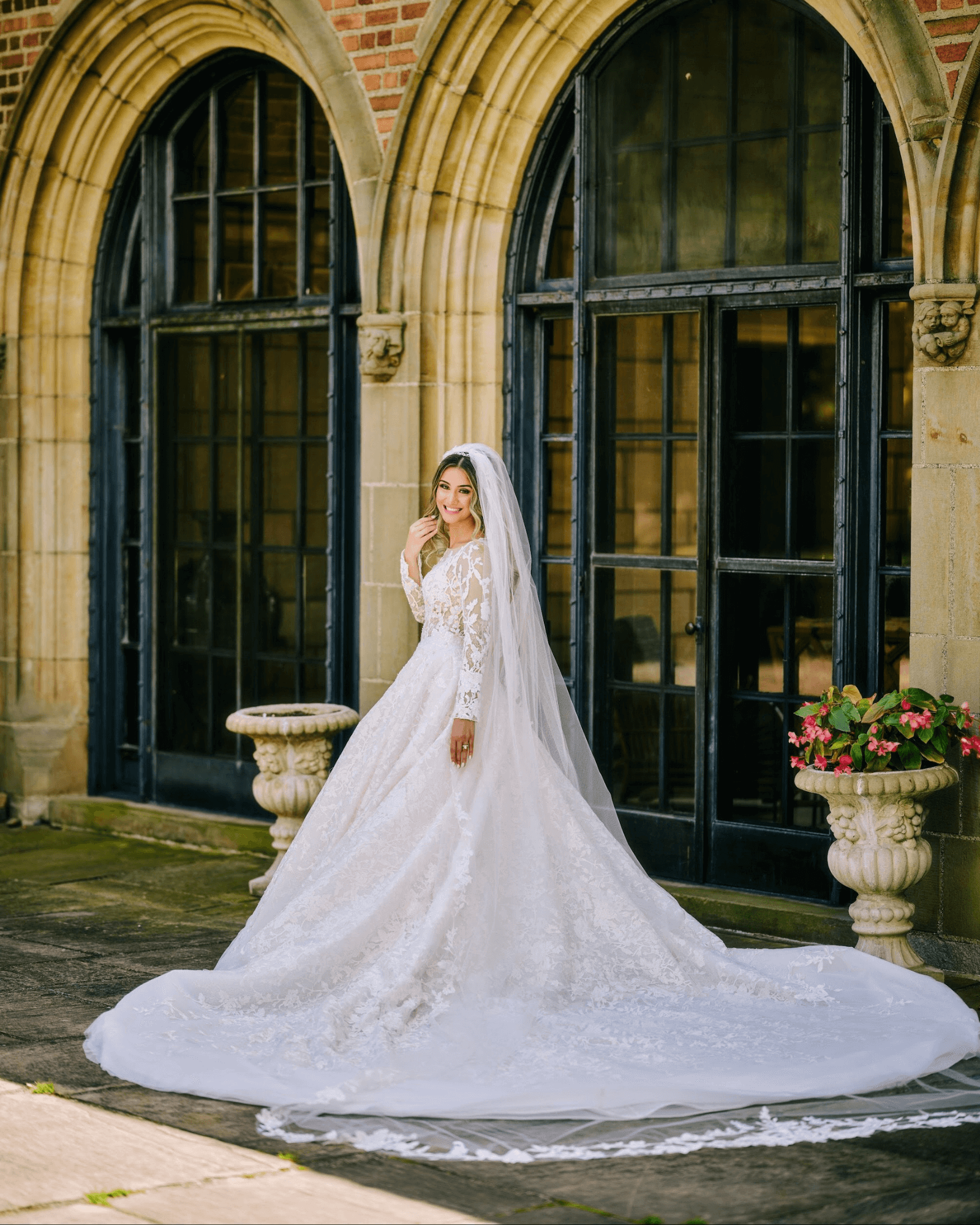 Bride in long sleeve ball gown with an elegant veil