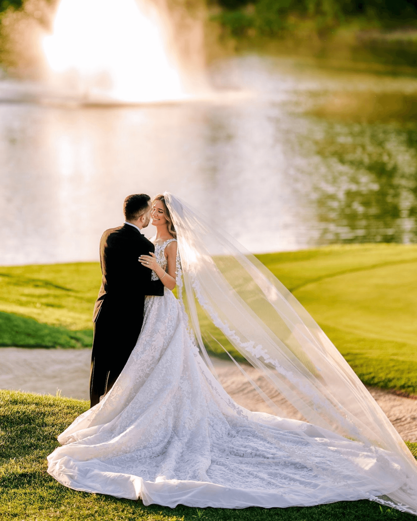 Bride in long sleeve ball gown with an elegant veil. Husband again bride
