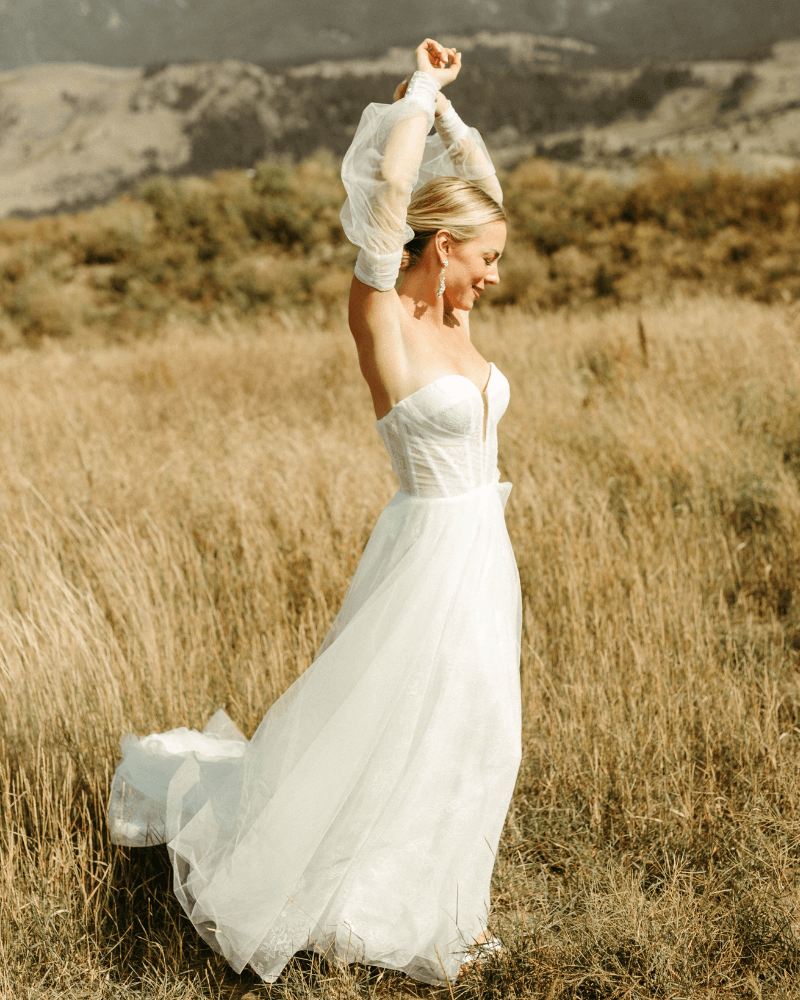 Bride in field with strapless a-line gown